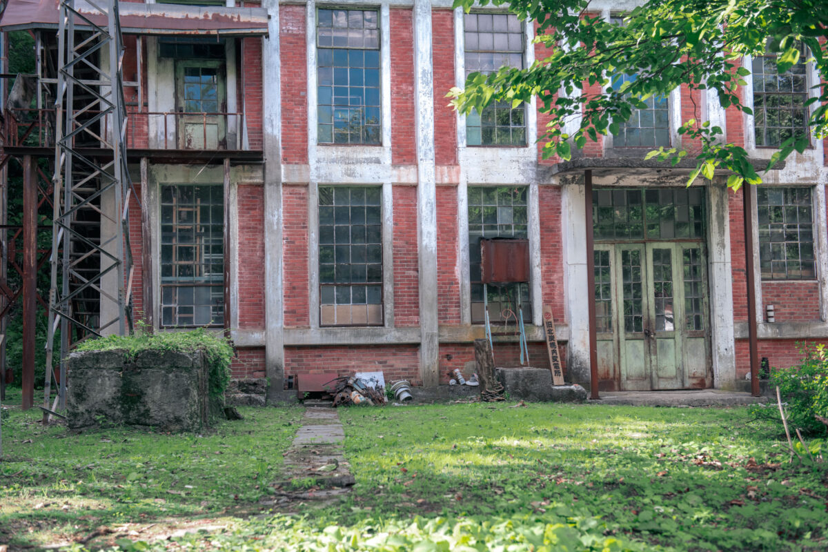 Abandoned Horonai Coal Mine Building in Hokkaido, Japan with weathered red brick structure.