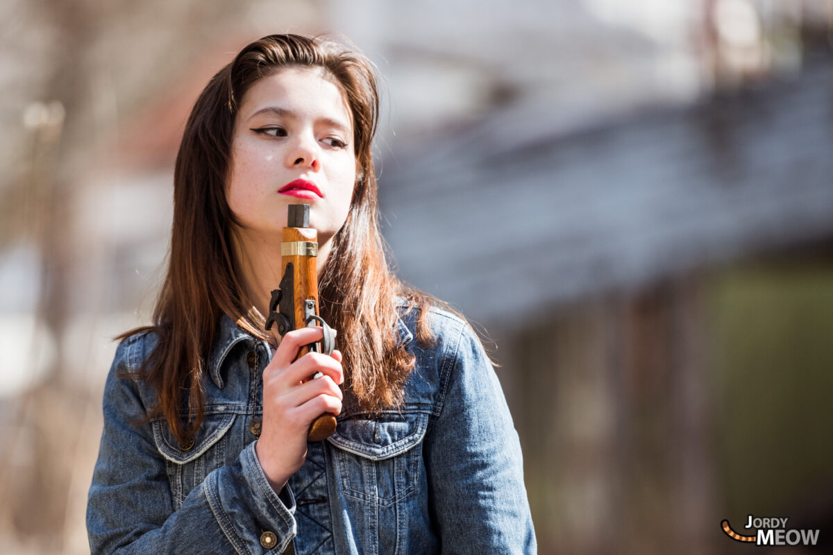 Young woman vaping at abandoned Japanese theme park.