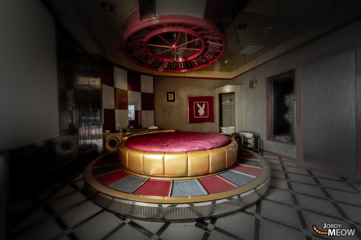 Abandoned vibrant Japanese love hotel interior remnants.
