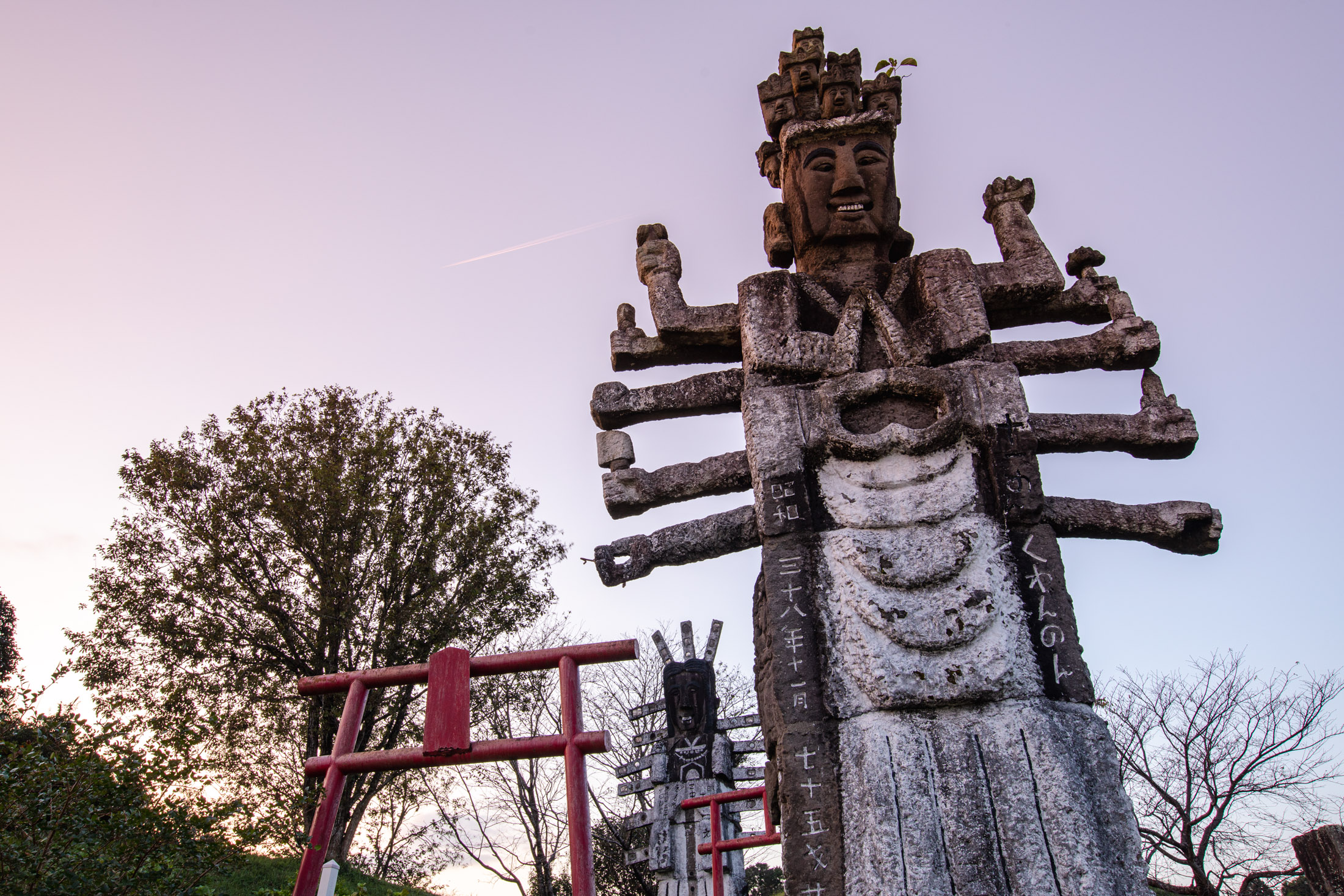 Intricately carved multi-armed wooden deity statue at Japanese shrine