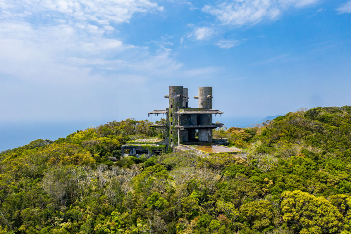 Abandoned New Muroto Sky Resort atop forested hill overlooking the Pacific Ocean