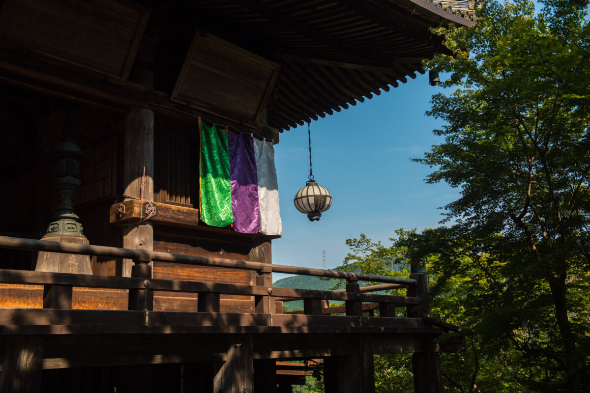 Hase-dera Temple main hall wooden pavilion with green and purple banners, Nara, Japan.