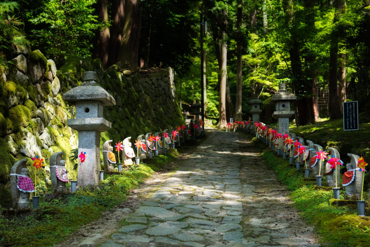 Stone path to Kongōrin-ji Temple lined with Jizo statues in Shiga, Japan.