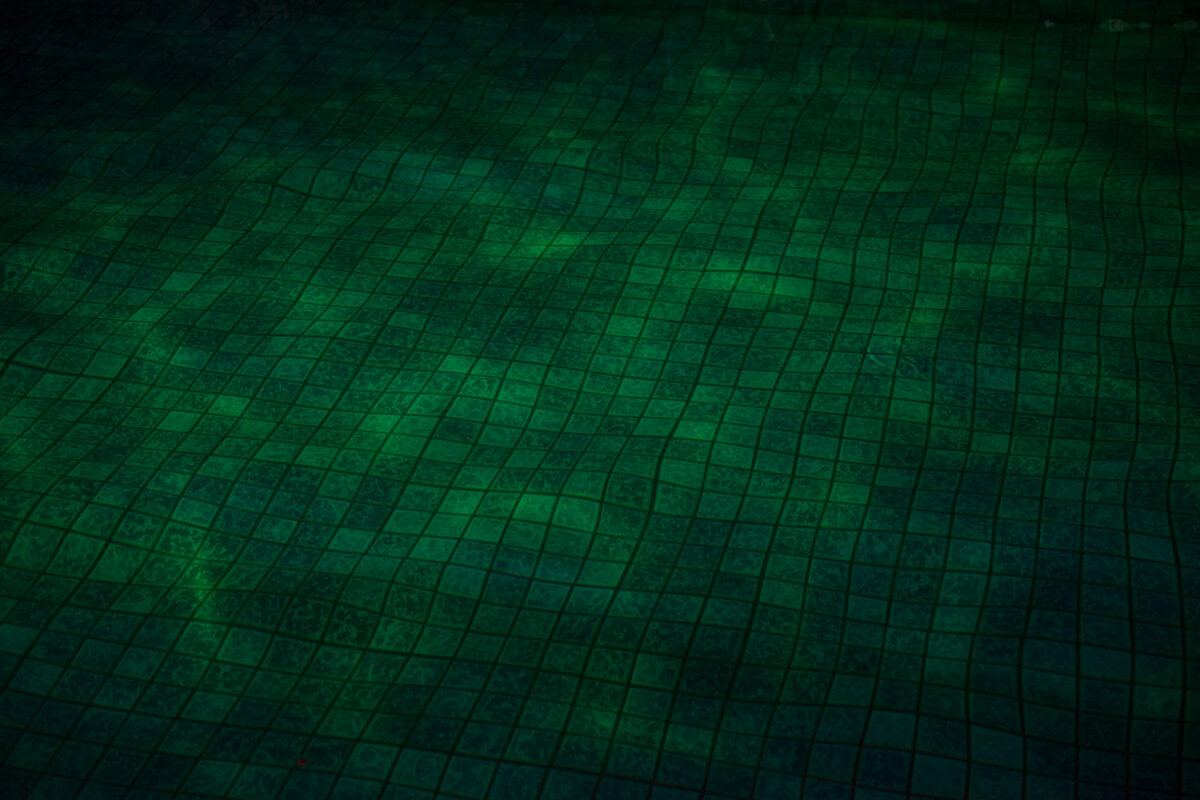 Abstract aerial texture of Miyako Island in green and teal with subtle grid pattern.