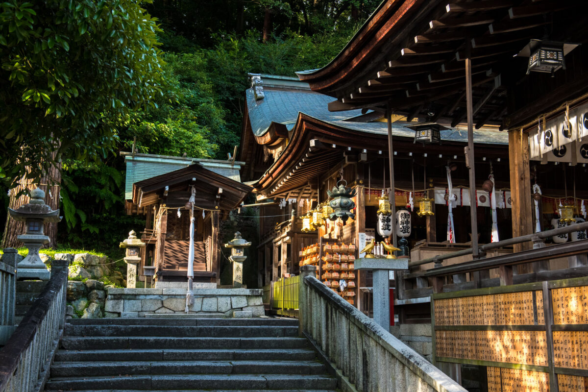 Stone steps leading to Omihachiman Shrine, Shiga, Japan, with lanterns and wooden buildings.