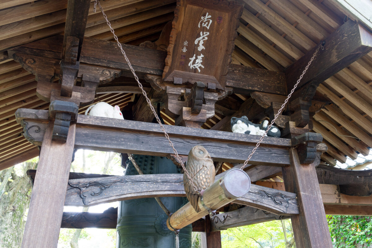 Upward view of Unrin-ji temple bell pavilion with bronze bell and wooden beams